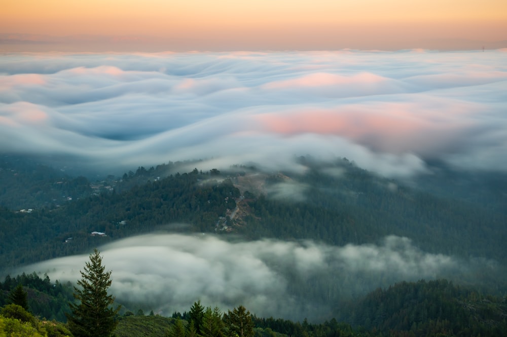 a view of a mountain covered in clouds