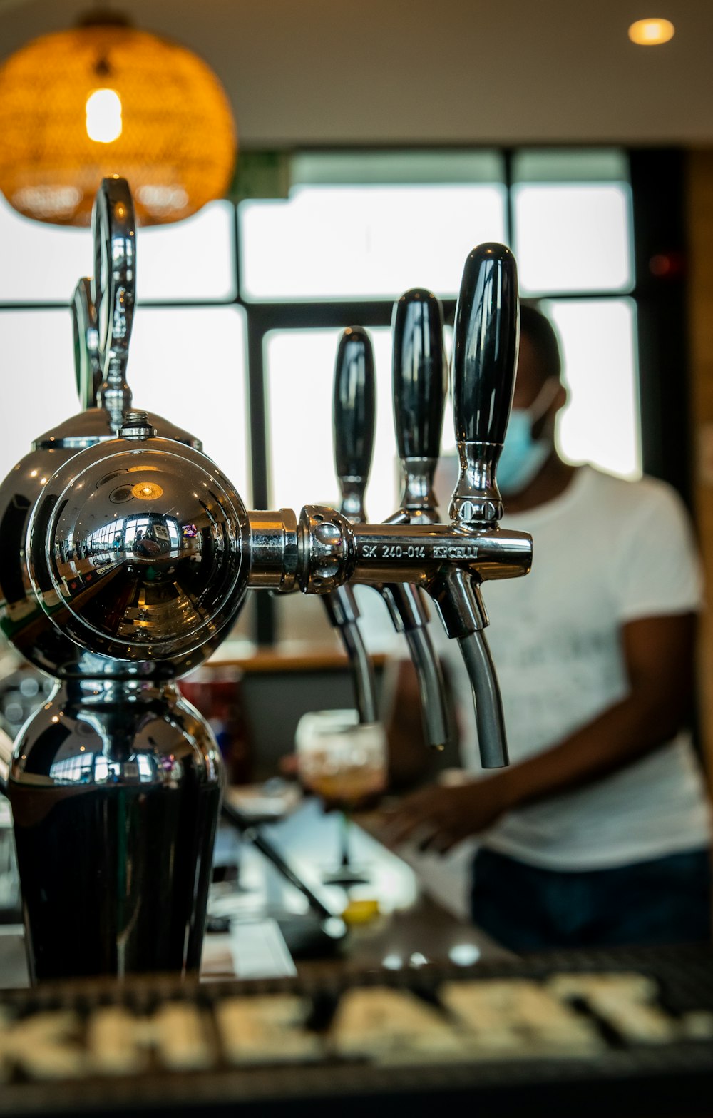 a close up of a coffee machine with a person in the background