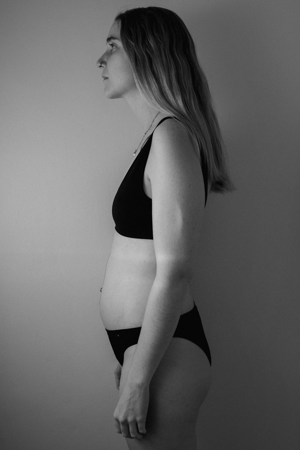 a black and white photo of a pregnant woman