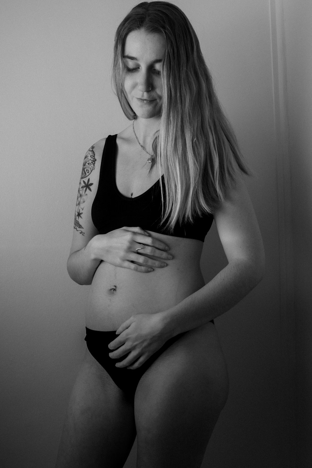 a black and white photo of a pregnant woman