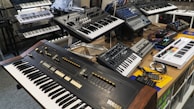 Modern studio setup with synthesizers and electronic music equipment.