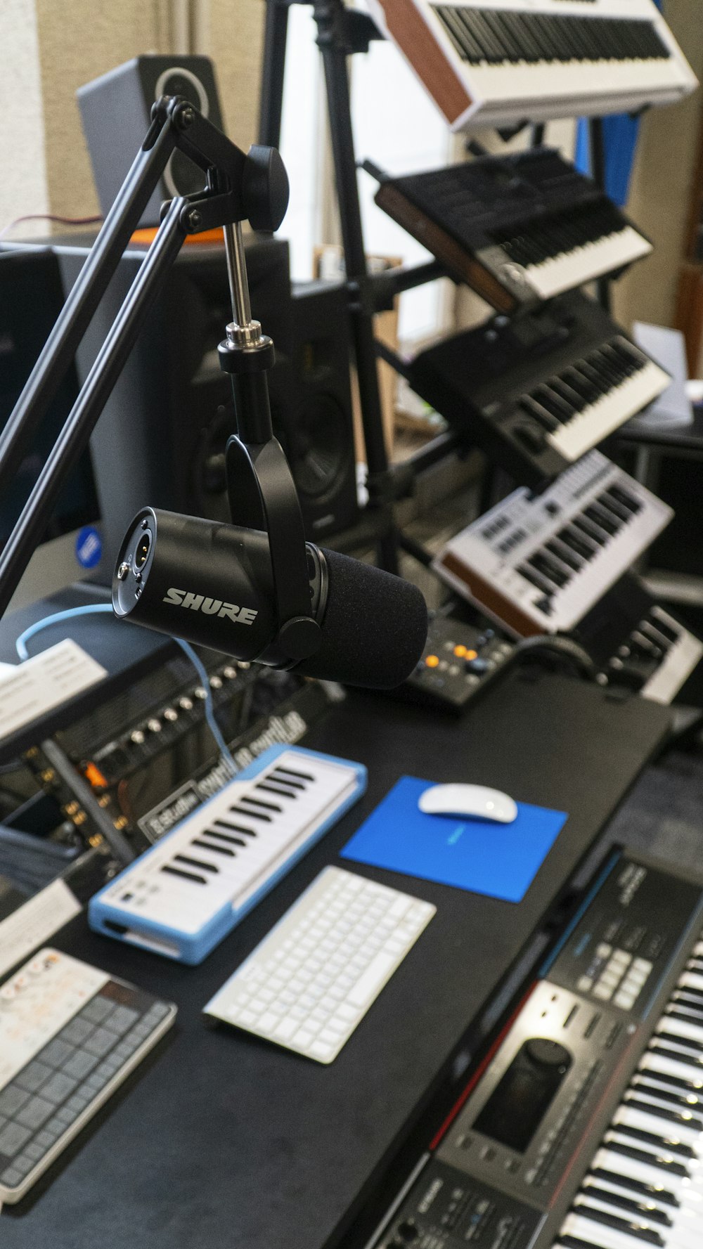 a recording studio with a microphone and keyboard