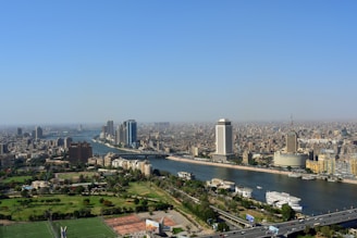 A panoramic view of a luxury high-rise with balconies overlooking the river.