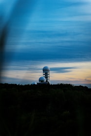 a large satellite dish sitting on top of a hill