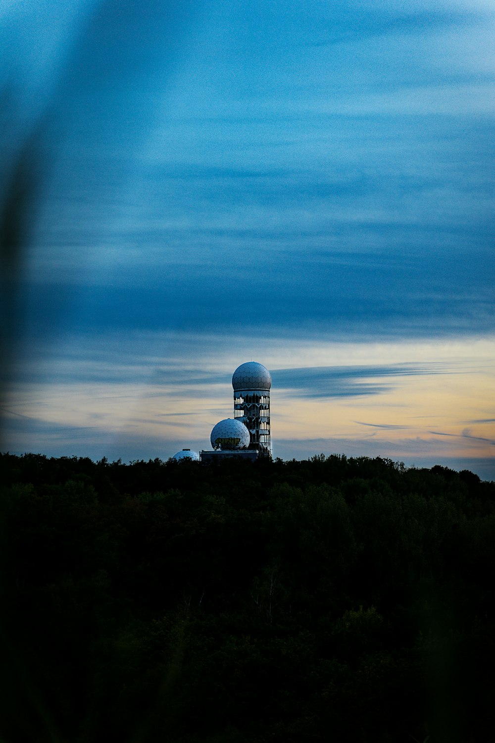 a large satellite dish sitting on top of a hill