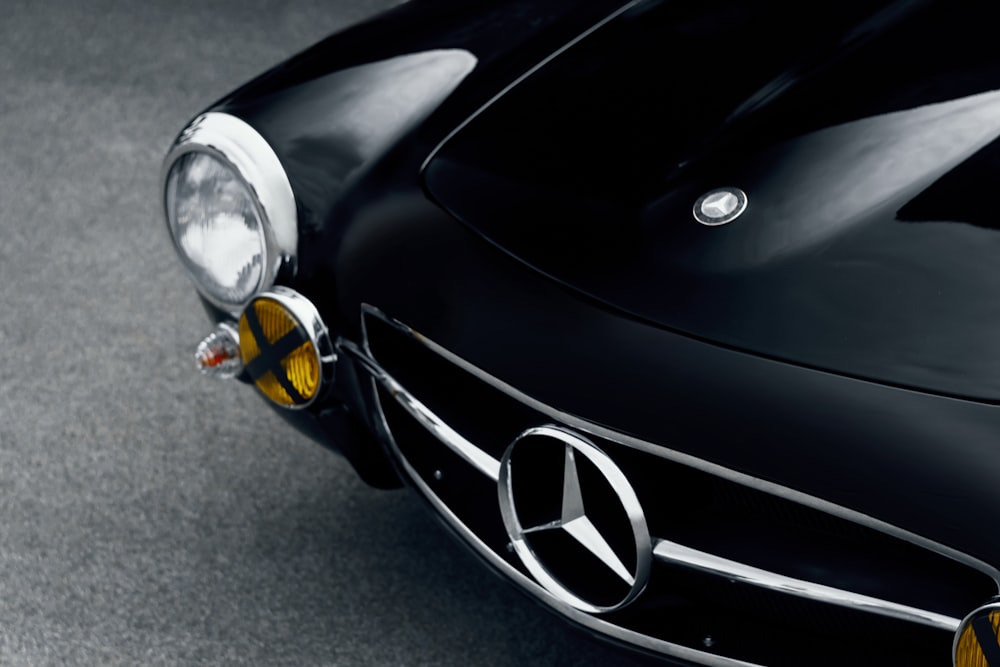 a close up of the front of a black mercedes sports car