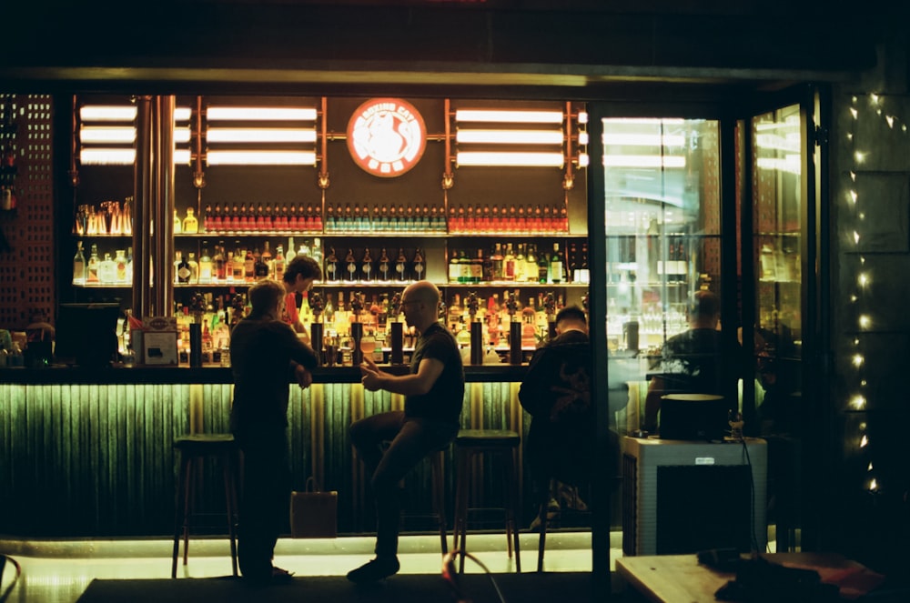 a couple of people sitting at a bar