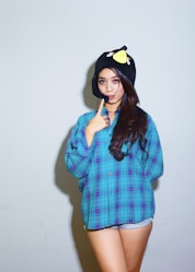 a woman wearing a blue shirt and a black hat