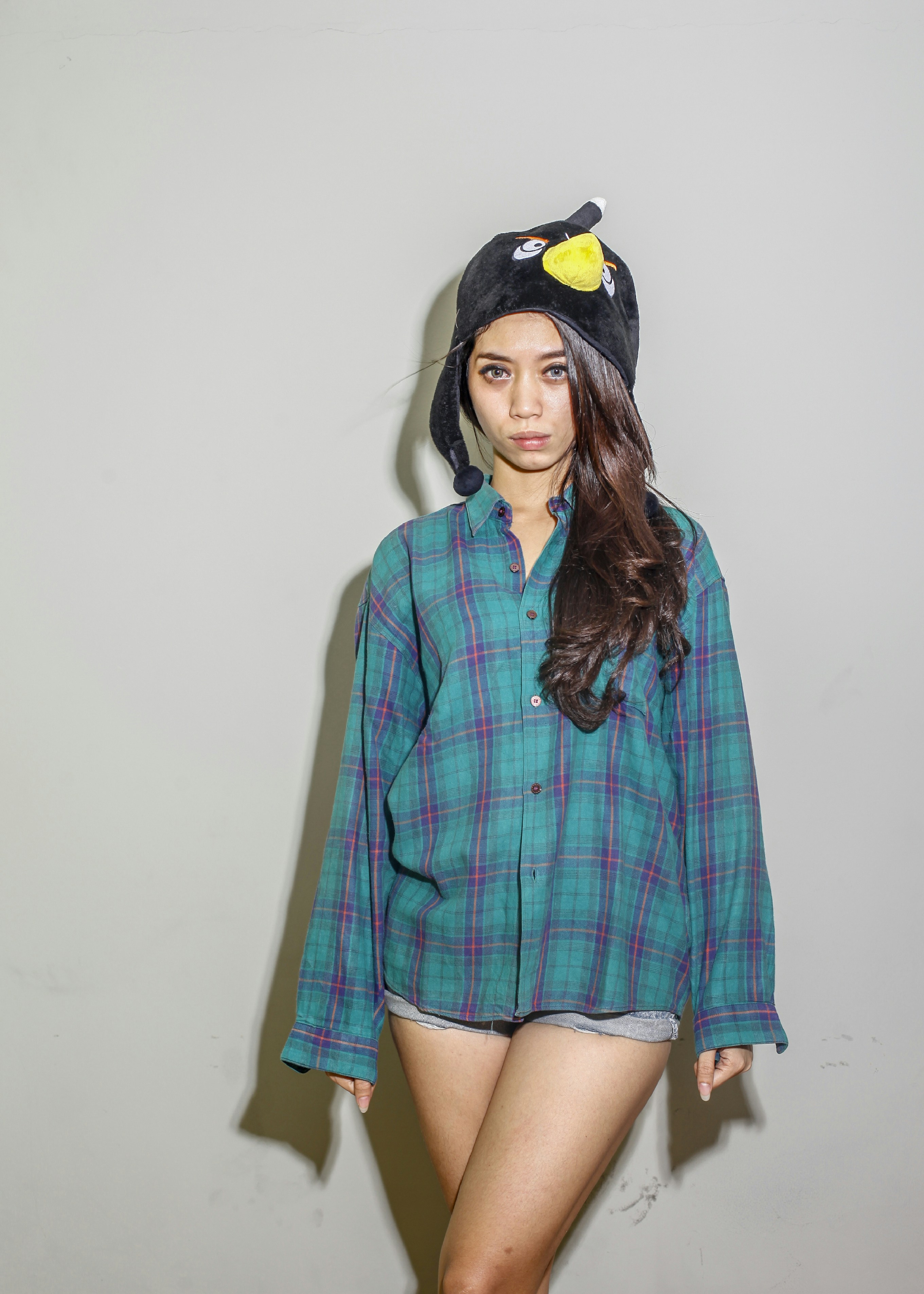 a woman in a green shirt and a black hat