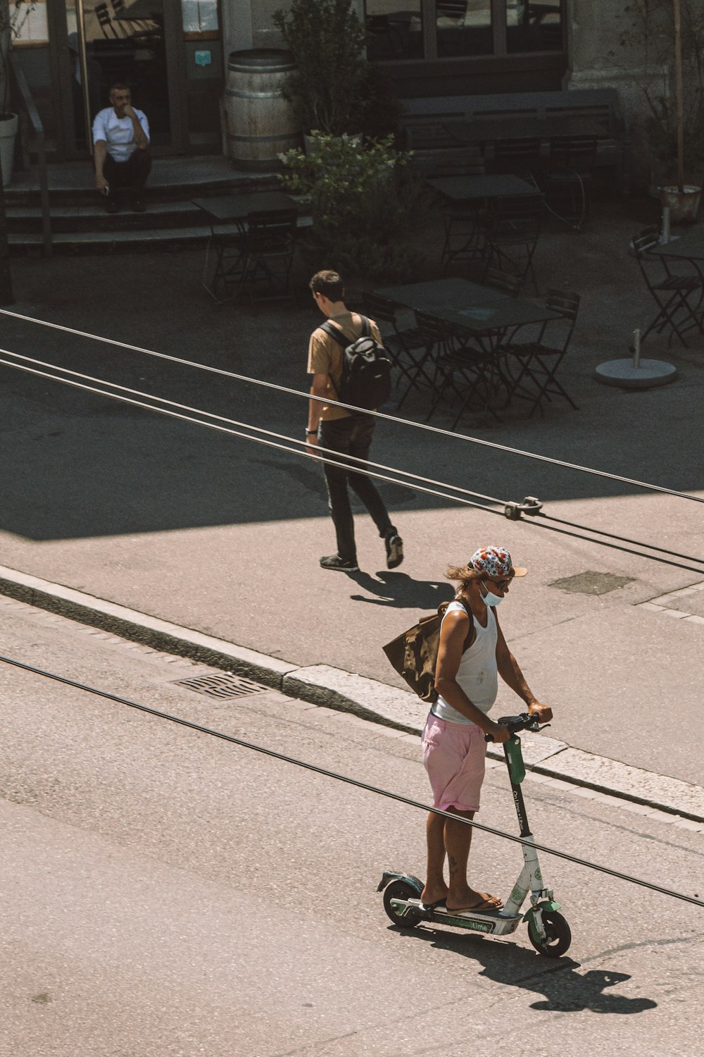 a woman riding a scooter down a street