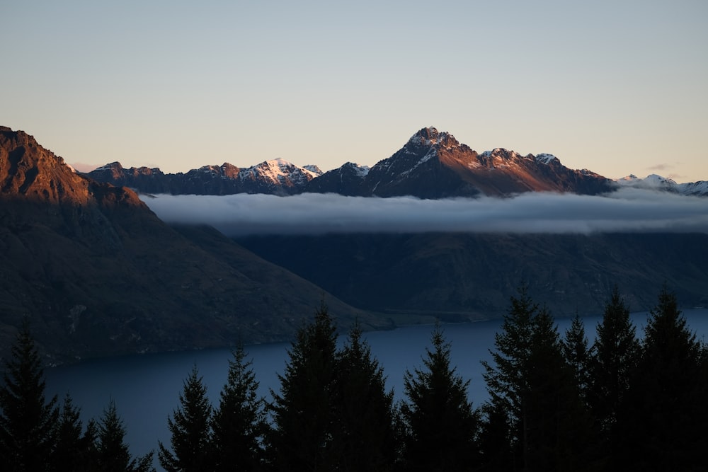 a view of a mountain range covered in clouds