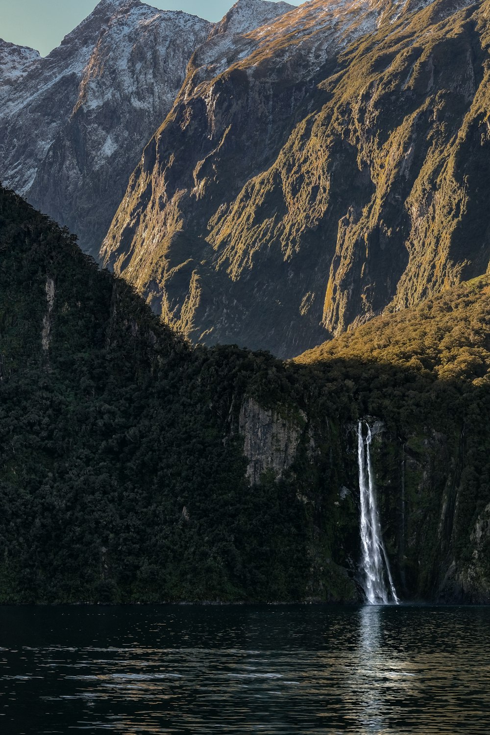 a waterfall in the middle of a mountain range