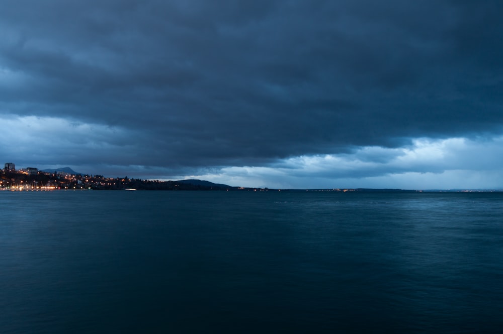 a large body of water under a cloudy sky