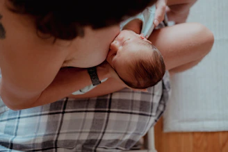 a woman holding a baby in her lap