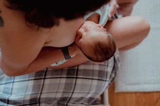 a woman holding a baby in her lap