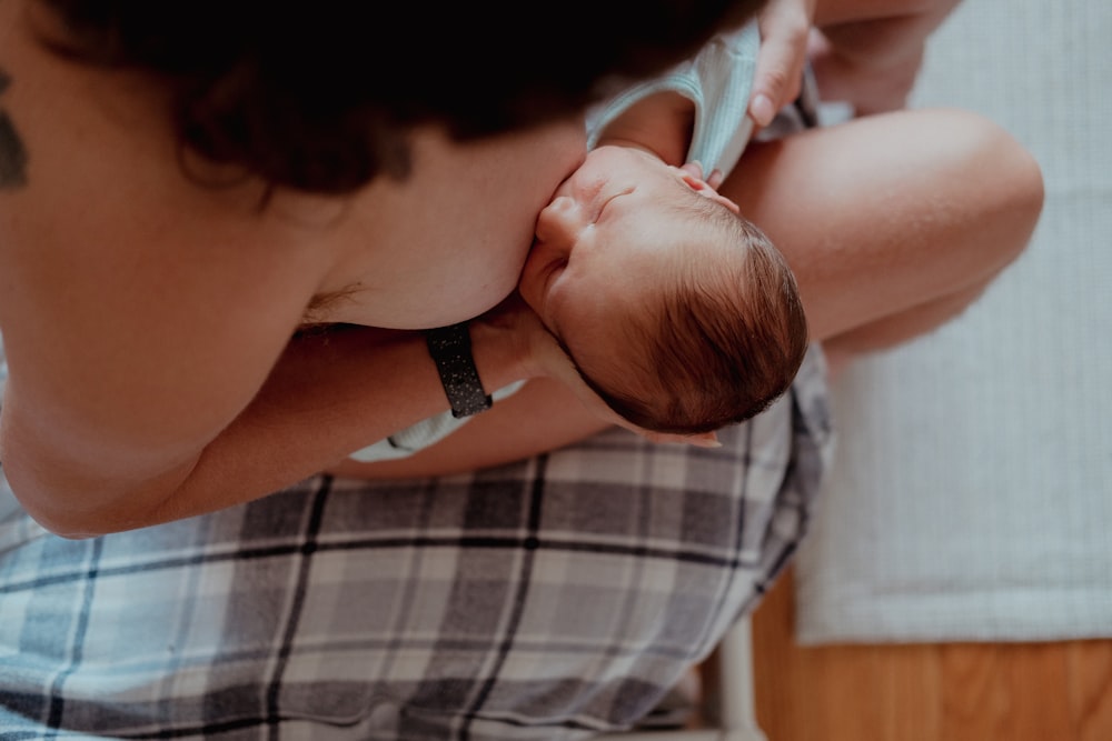 a woman holding a baby in her lap