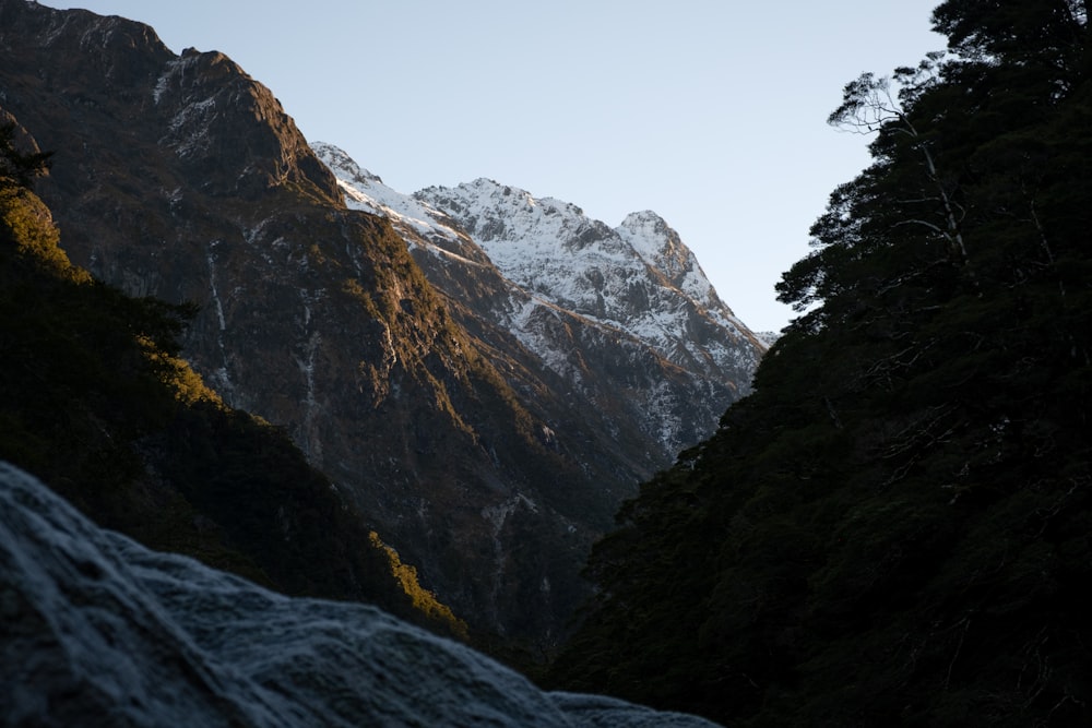 a view of a snowy mountain range from below