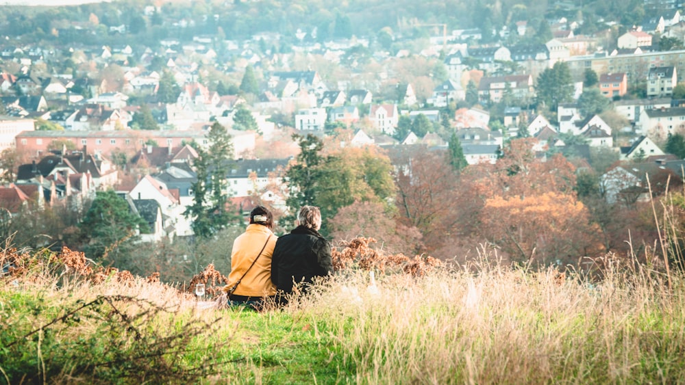 a couple of people that are standing in the grass