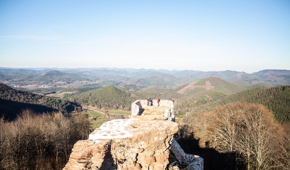 a group of people standing on top of a mountain