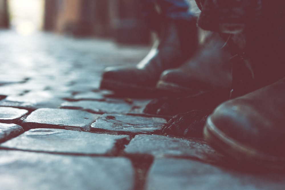 a close up of a row of shoes on a sidewalk