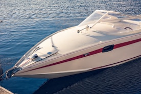 a white and red boat in a body of water