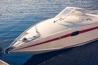a white and red boat in a body of water