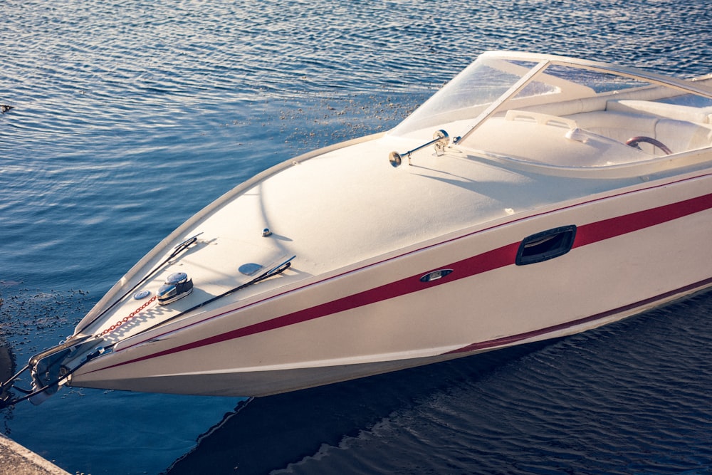 a white and red boat in a body of water