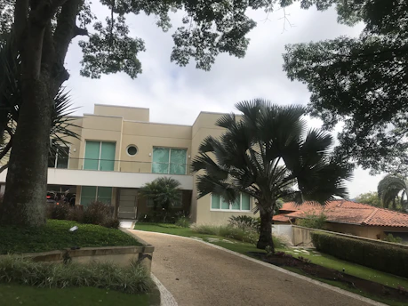 Elegant modern family home with a welcoming entrance and lush landscaping.