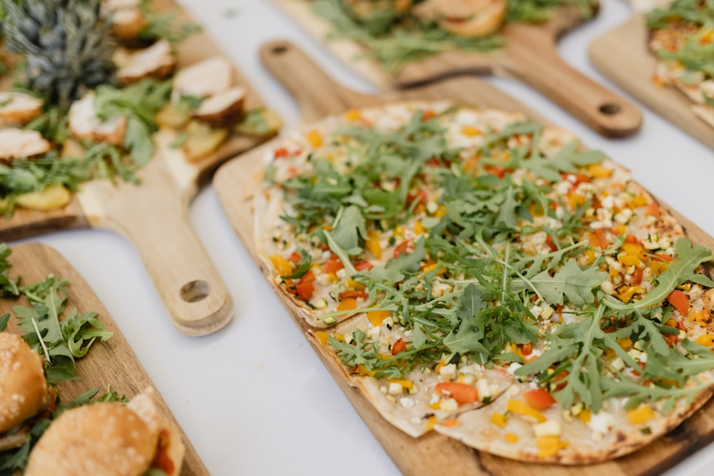 a table topped with pizzas covered in toppings