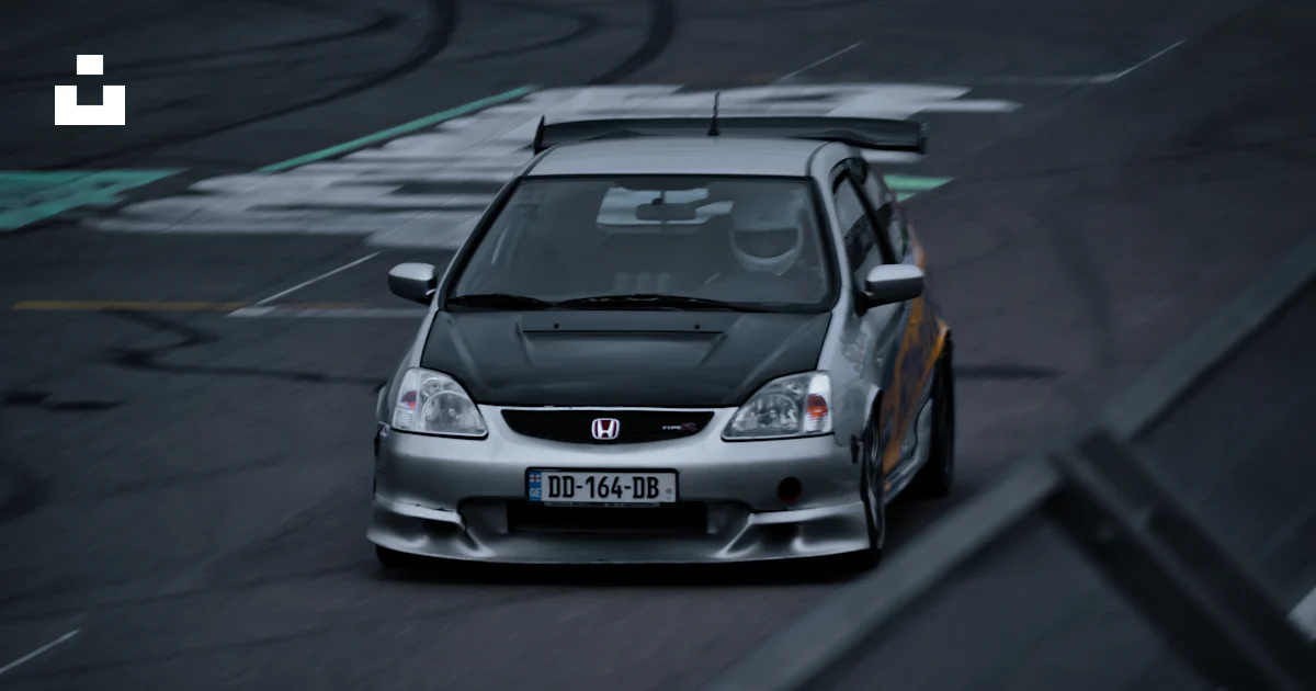 A silver car driving down a race track photo – Free Rustavi ...