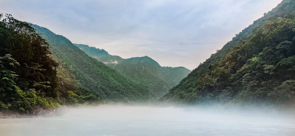 a body of water surrounded by mountains and trees