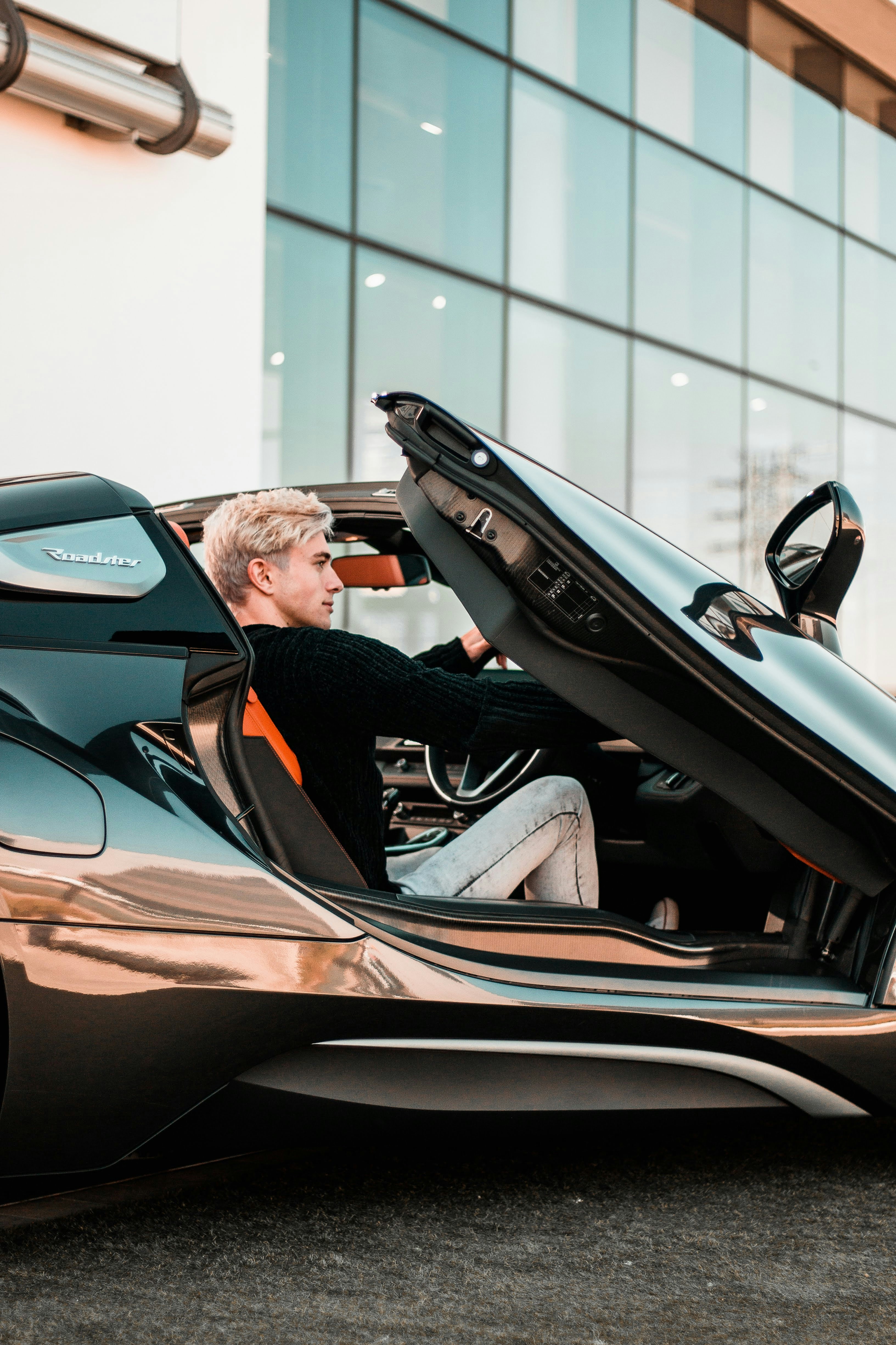a man sitting inside of a futuristic car