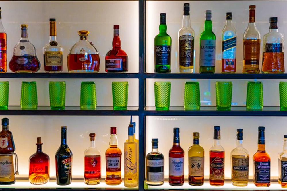 a shelf filled with lots of different types of liquor
