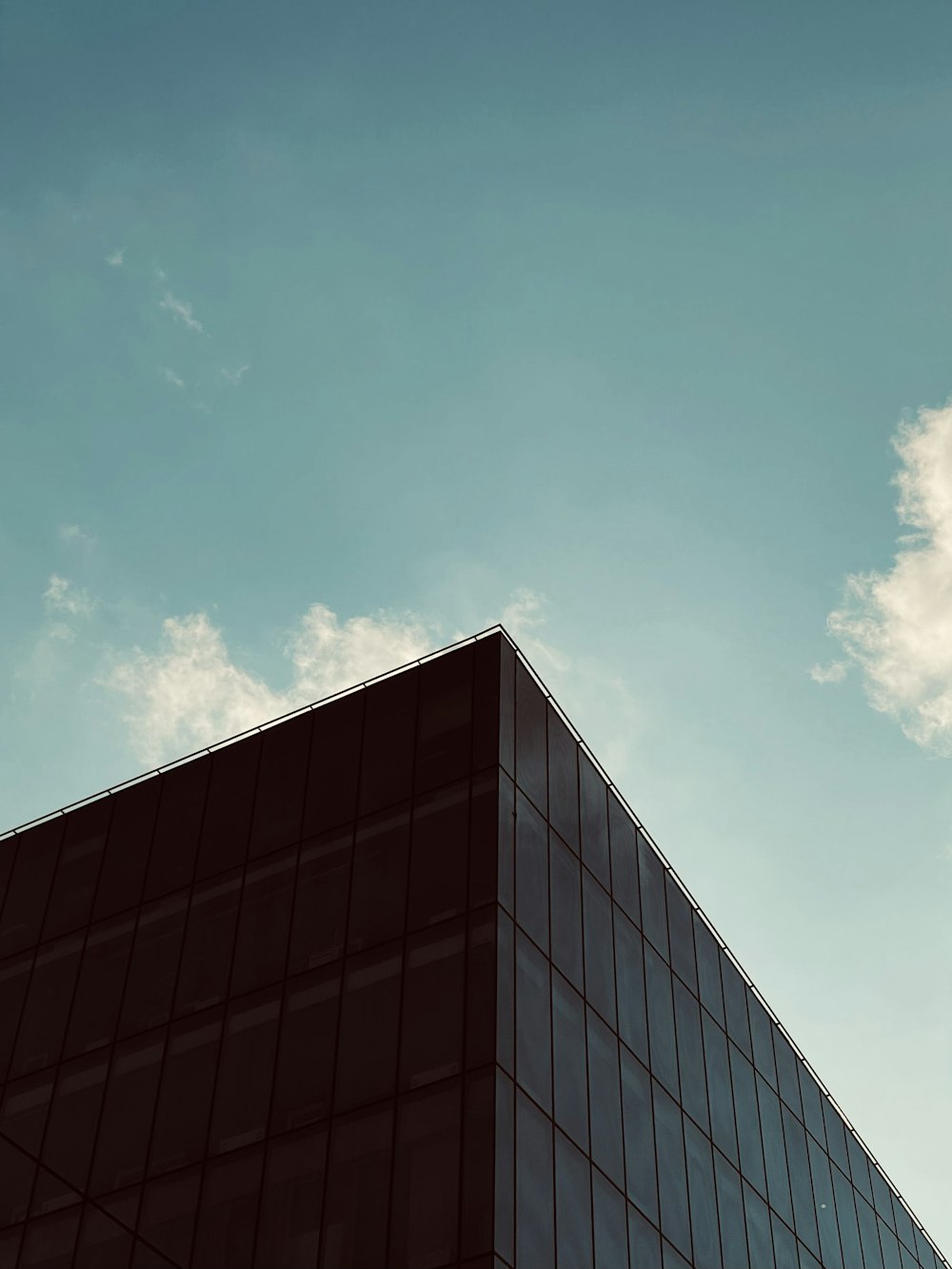 a tall building sitting under a blue sky