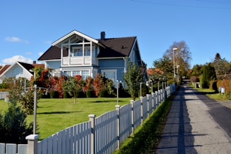 a house with a white picket fence in front of it