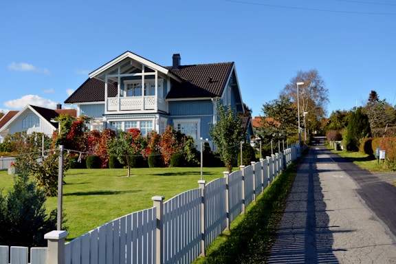 a house with a white picket fence in front of it