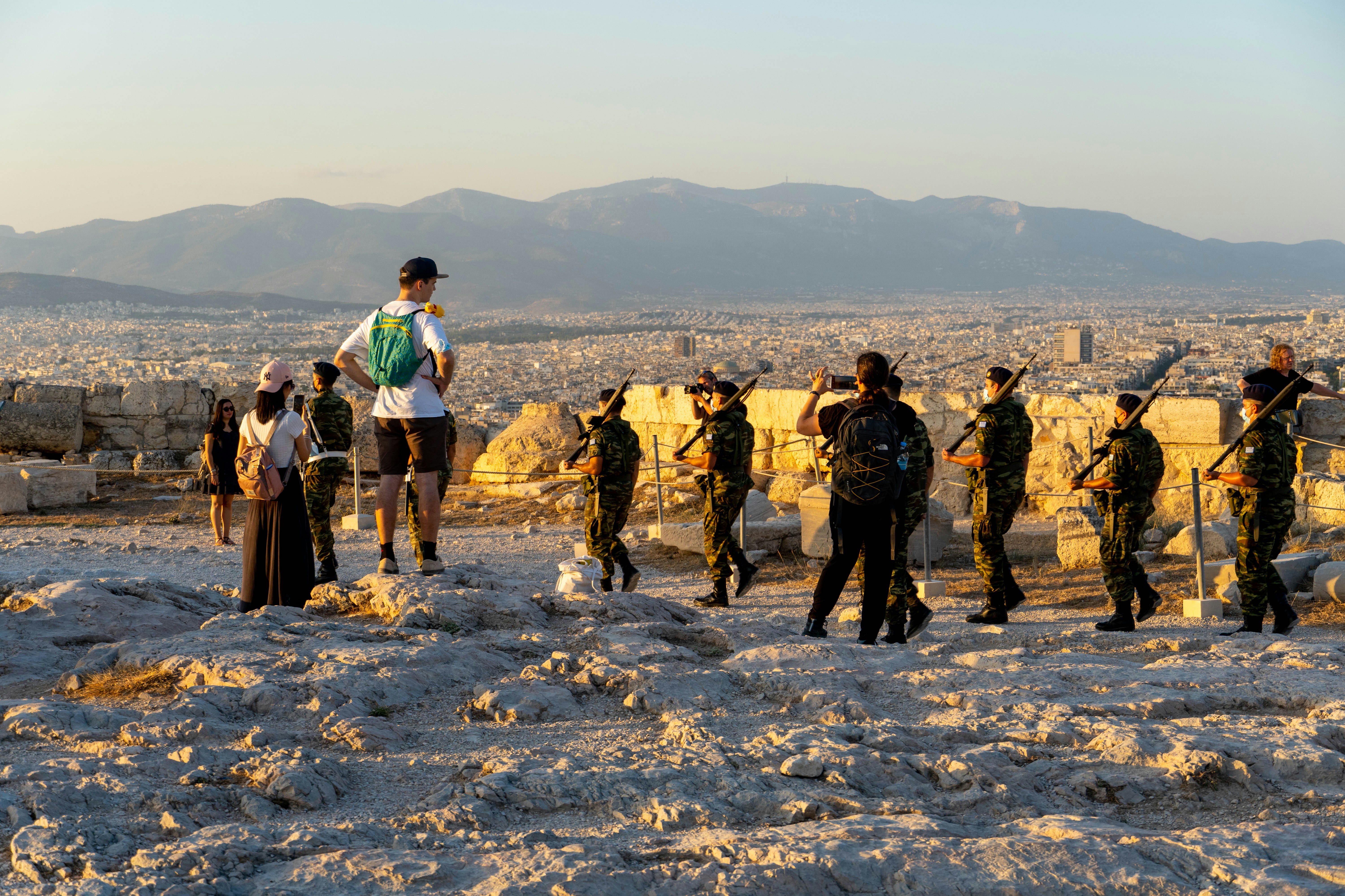 a group of people standing on top of a sandy beach