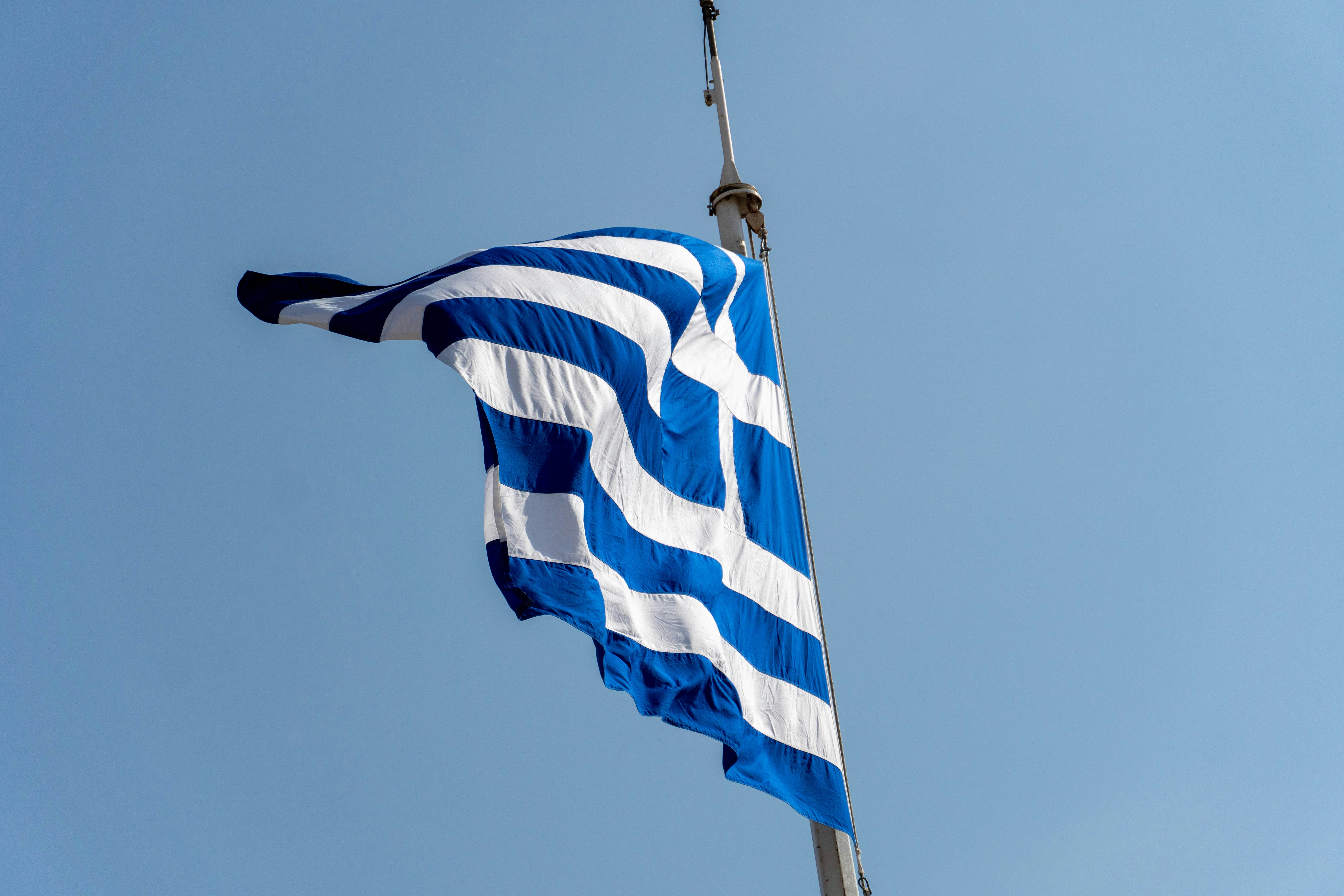 a blue and white flag flying in the wind