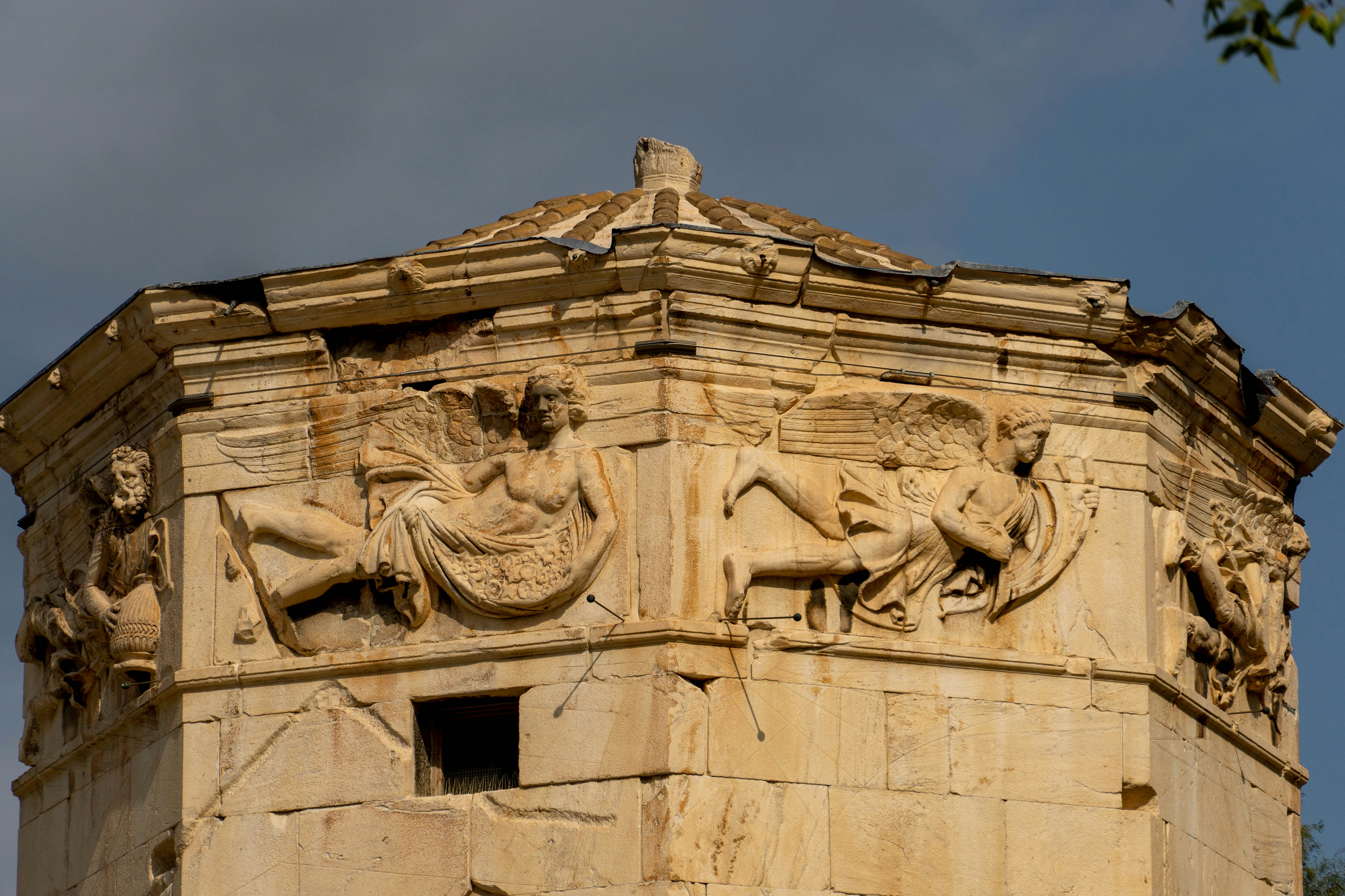 a tall building with a statue on top of it
