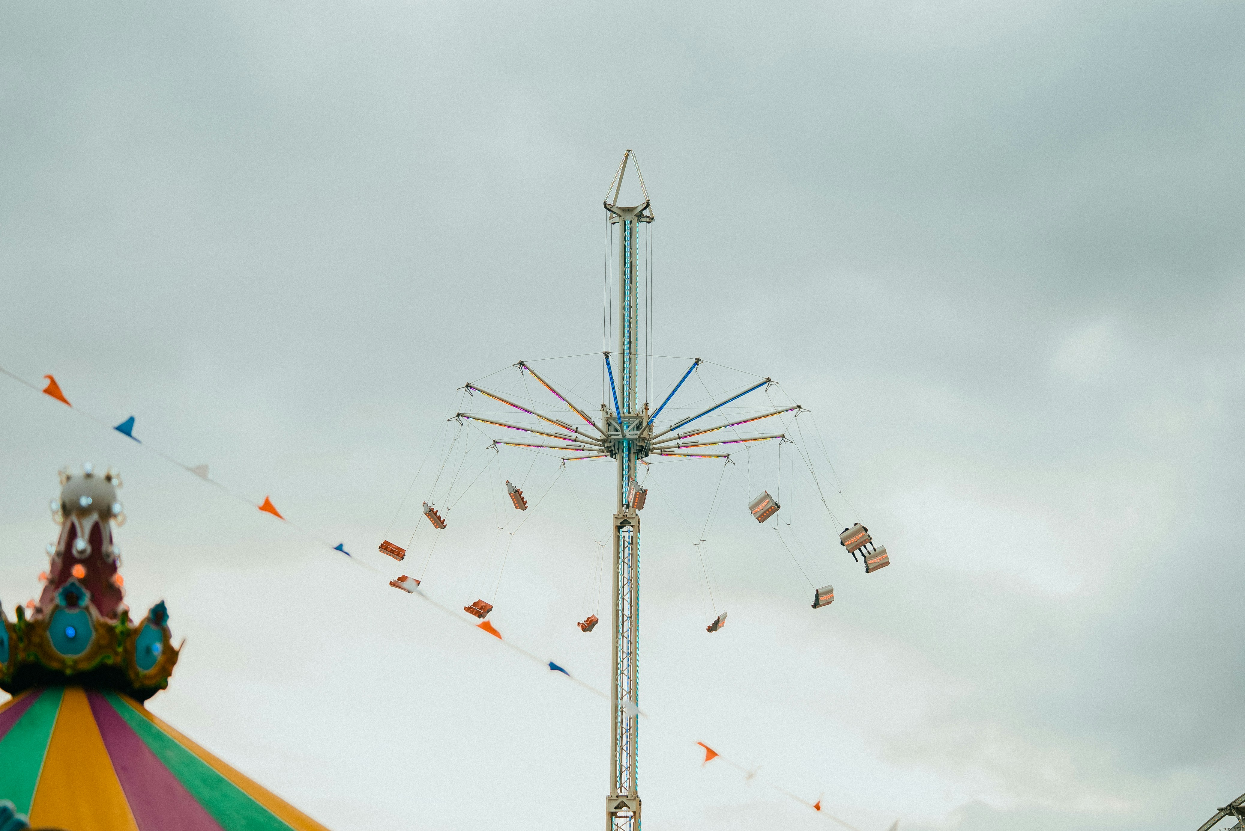 a carnival ride with a carnival carousel in the background