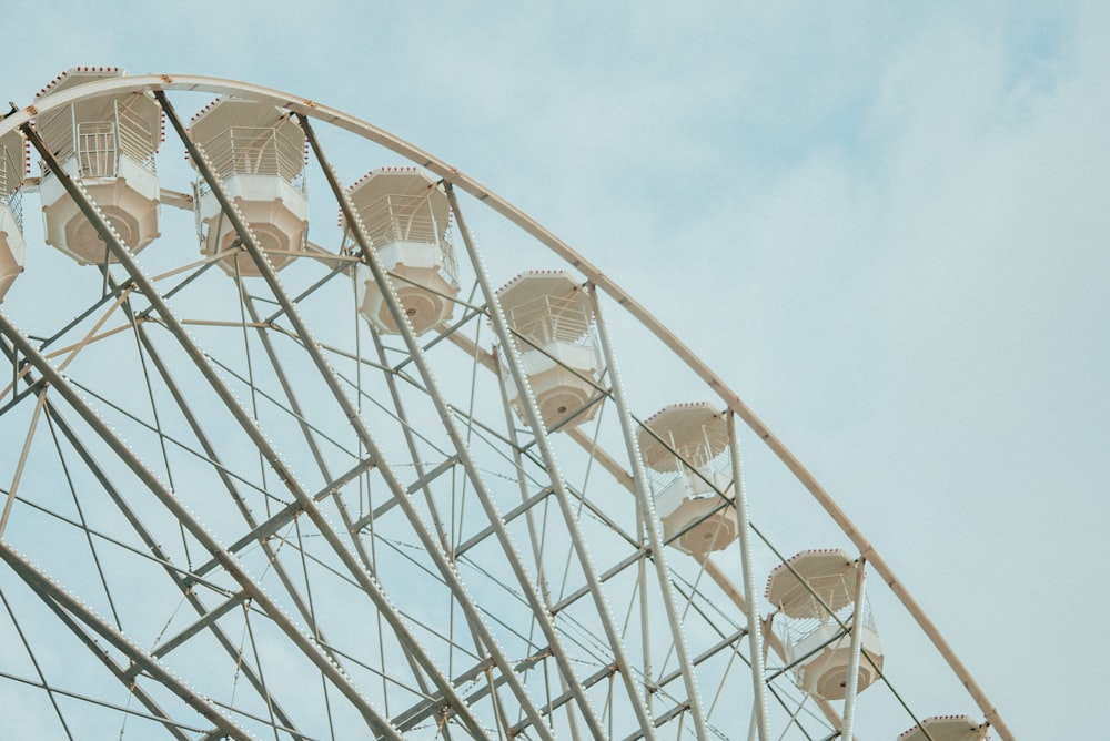 a large ferris wheel sitting under a blue sky