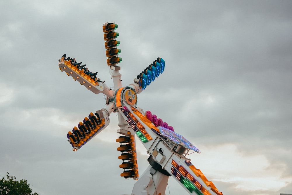 a carnival ride with a colorfully decorated ferris wheel