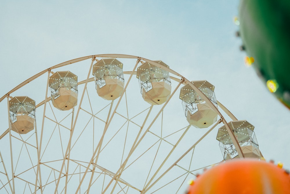 a large ferris wheel sitting next to a giant balloon