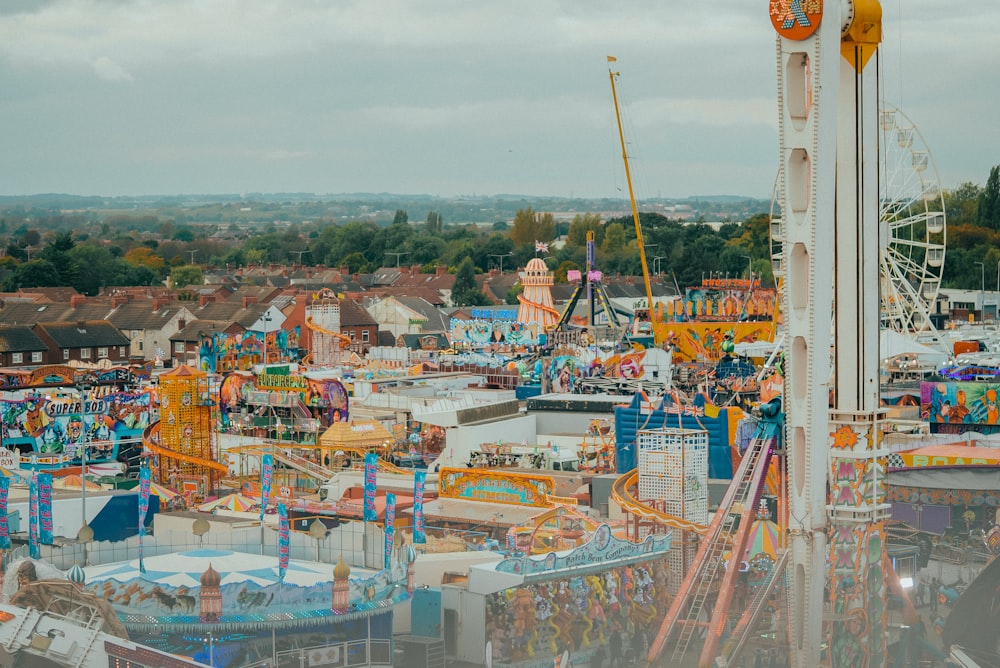 a carnival park with a ferris wheel and rides