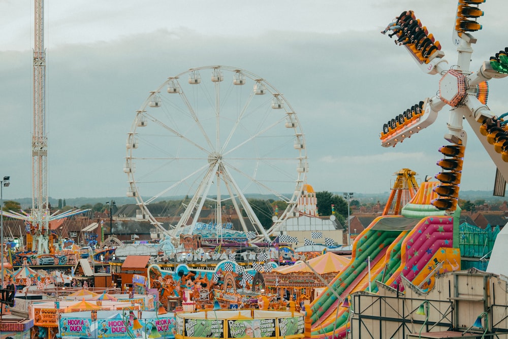 a carnival with a ferris wheel in the background