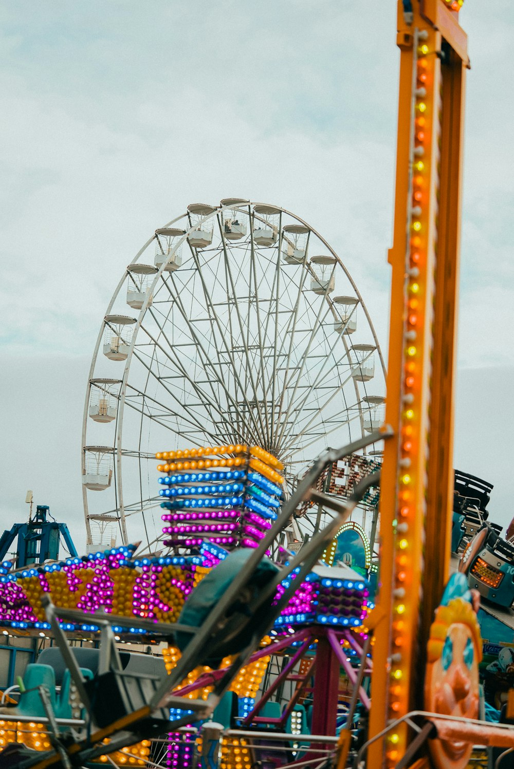 a carnival ride with a ferris wheel in the background