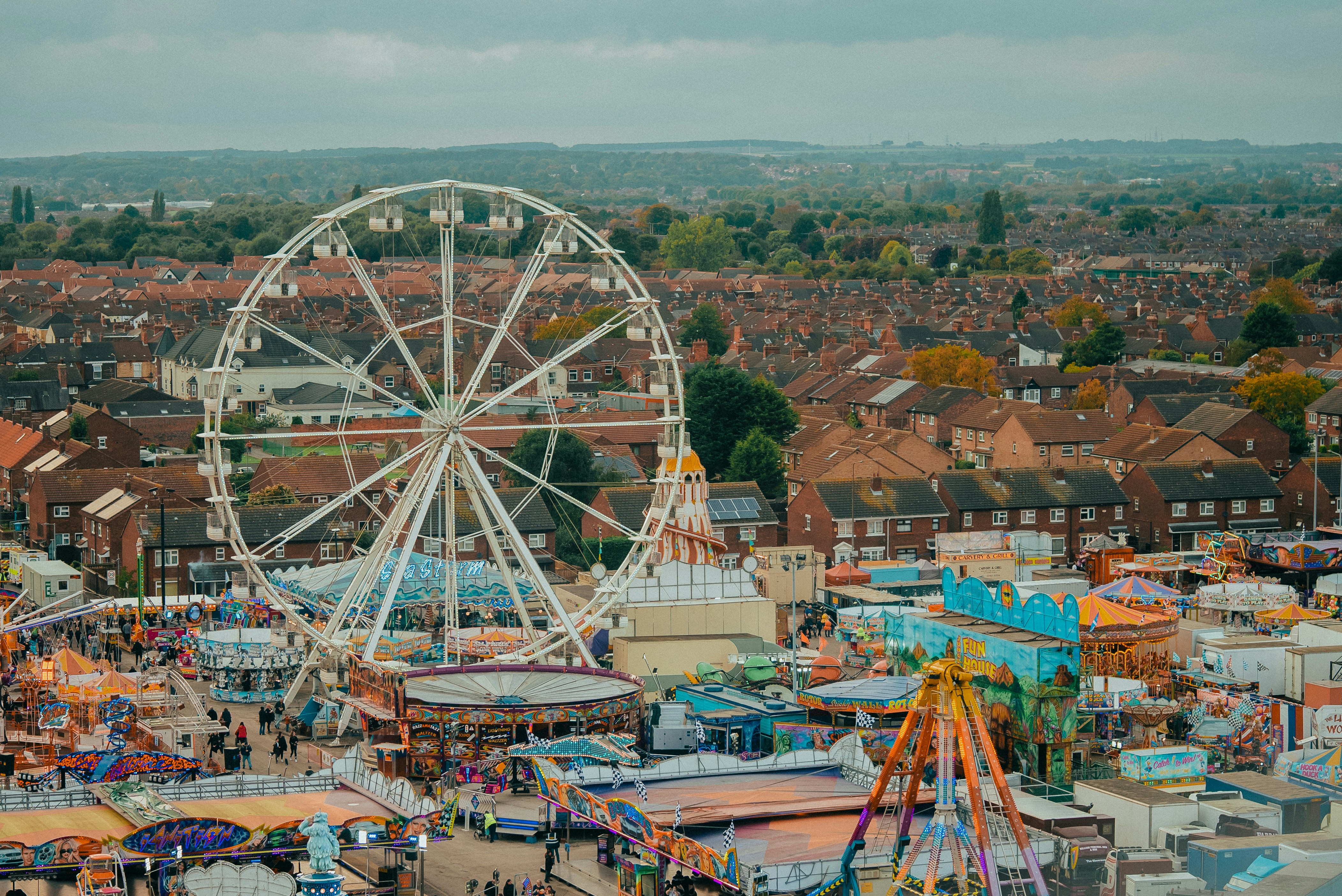 an aerial view of a carnival with a ferris wheel