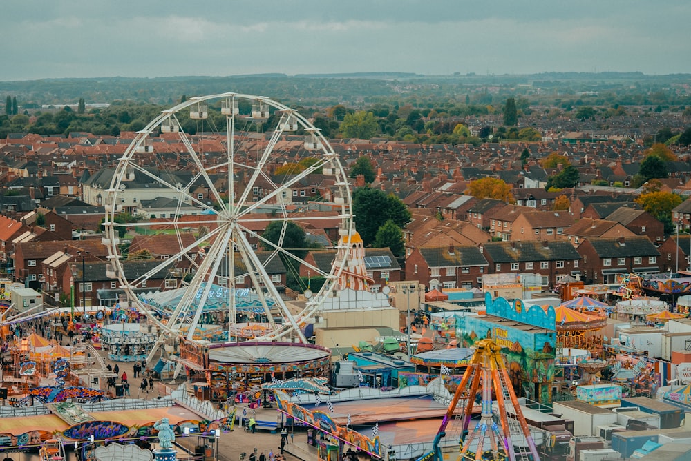 an aerial view of a carnival with a ferris wheel