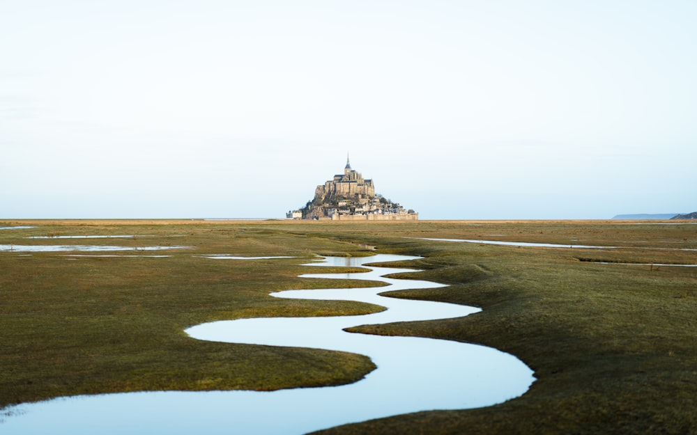 a large castle sitting on top of a lush green field