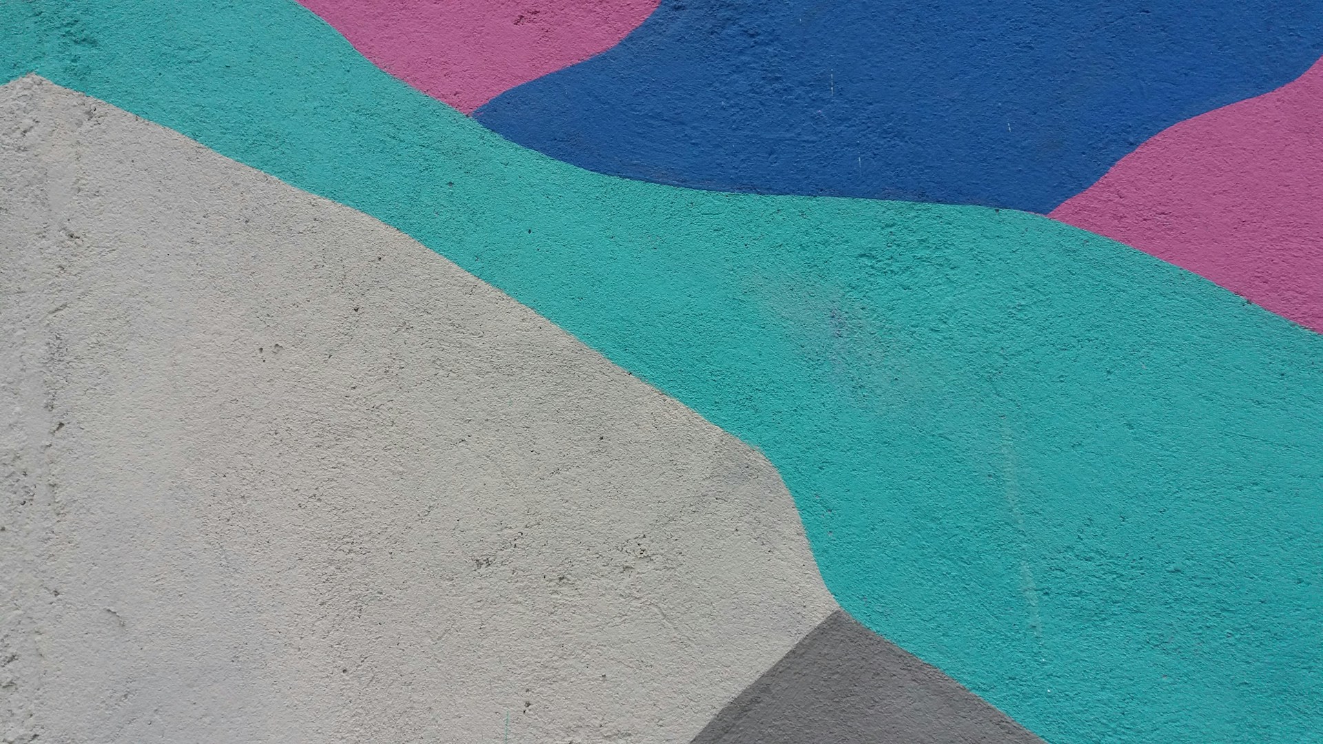 a skateboard is leaning against a colorful wall